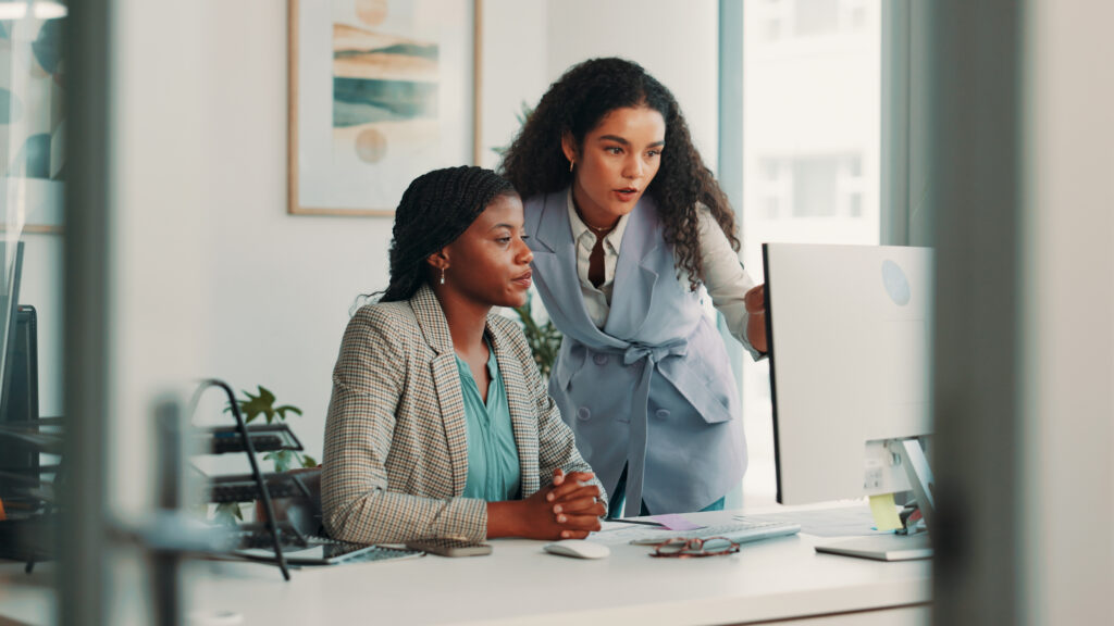 teamwork, business people and women in office, computer and help with conversation, publishing and advice. employees, coaching or mentor in workplace, editorial staff or female empowerment with email